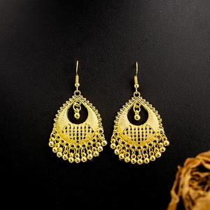 Bohemian gold peacock bell tassel earrings with intricate ethnic hollow metal details
