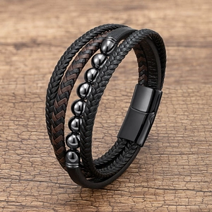 Multilayer braided leather men's bracelet with dark beads and magnetic buckle on wood