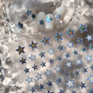 Deep blue holographic star nail art stickers with glitter effects on white base