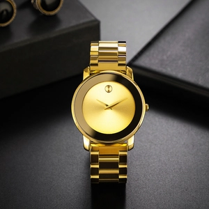 Detail view of gold metal strap and minimalist black dial with signature dot at 12 o'clock