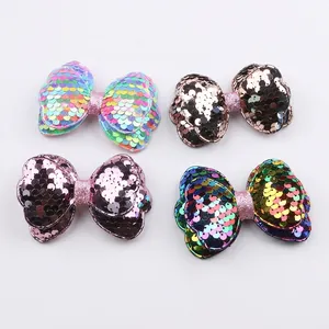 DIY handmade sequined bow hair clips in four vibrant colors on a white background