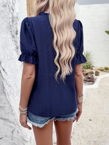Back view of women's dark blue textured short sleeve top with ruffle cuffs and puff sleeves