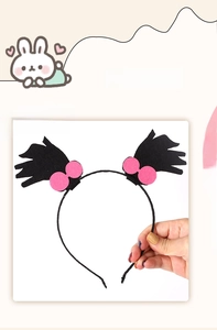 Detail of creative Halloween headband featuring black faux hair tufts and pink circle accents