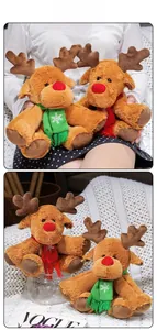Detail of plush Christmas reindeer toys with embroidered scarves and soft brown fur texture