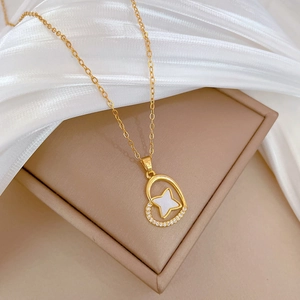 Detail of gold heart pendant with star shell inlay and micro-pave diamonds on chain