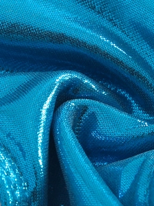 Detail of blue shimmering knitted swimsuit fabric with metallic finish and soft texture