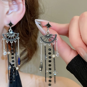 Detail of gothic silver drop earrings with black crystal tassels and dangling water-drop pendants