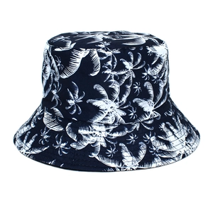 Detailed close-up of dark blue bucket hat with white tropical coconut tree prints