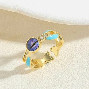 Detail of vintage gold ring with blue enamel and purple cat eye stone in macro view