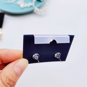 Detailed back view of earring studs with silver pins and clear plastic backings