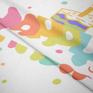 Close-up of soft flannel tapestry fabric showing colorful cartoon cake print detail