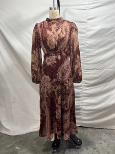 Detail view of burgundy paisley print chiffon maxi dress with high neck and long sleeves