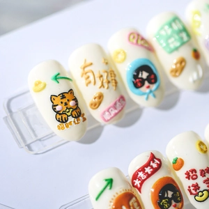 3D embossed nail art stickers with traditional Chinese New Year motifs on white nails
