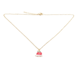 Detail of a Christmas bell pendant necklace with red enamel and green leaves on gold chain