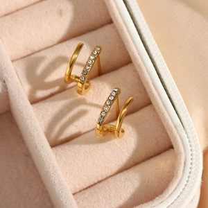 Macro shot of 18K gold plated double-layer huggie earrings with cubic zirconia in a box