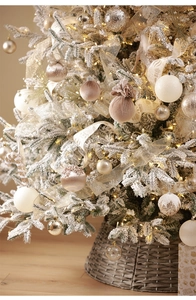 Detail of elegant champagne gold and cream white Christmas ornaments on a lighted tree