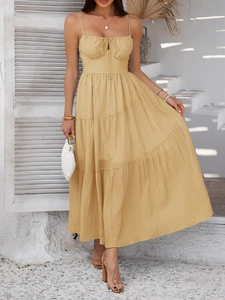 Detail of elegant apricot high waist pleated maxi dress with spaghetti straps in resort style