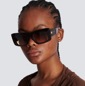 Close-up of cat-eye cycling sunglasses with tortoiseshell frame worn by a model