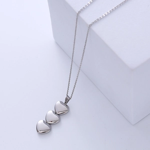 Silver stainless steel necklace featuring three polished heart pendants on a slim chain