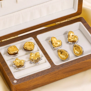 Two-tone geometric heart and flower earrings set in a wooden jewelry box