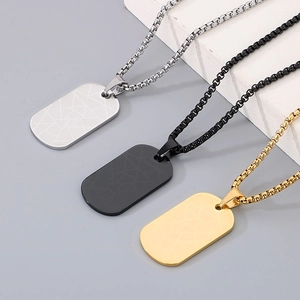 Close-up of geometric textured military tags in gold, silver, and black finish