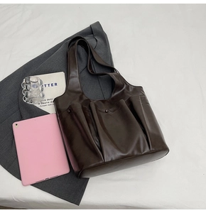 Detail of dark brown PU leather tote bag with functional pockets and large capacity