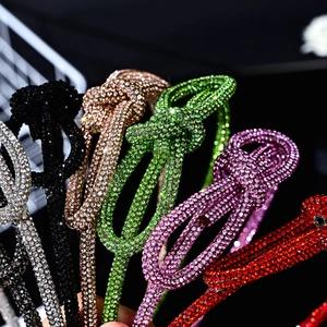 Detail shot of sparkling rhinestone knotted headbands in various colors with high-end texture