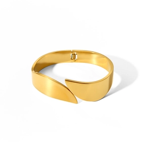 Close-up of high-polish gold stainless steel wide cuff bracelet with hinge closure