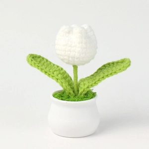 Detail view of a handcrafted crochet white tulip in a minimalist ceramic pot ornament