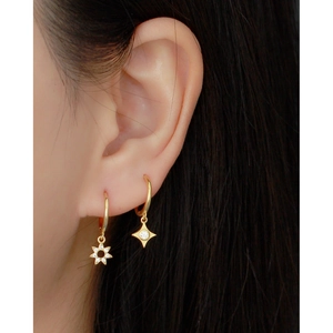 Luxurious S925 silver star earrings with gold plating and zircon stones worn by model