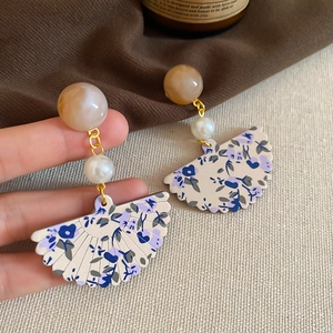 Detailed view of floral fan pendant earrings with resin pearls and s925 silver needles