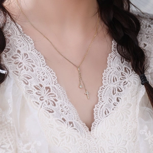 Elegant S925 silver gold cross Y-necklace with tassels and diamonds worn by a model