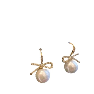 Elegant gold bow earrings with crystal rhinestones and round white pearl drops