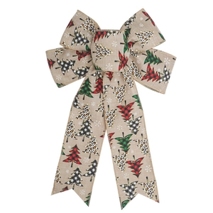 Close-up of handmade faux burlap Christmas bow with printed trees and snowflakes