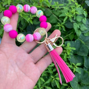 Vibrant silicone bead keychain bracelet with PU tassel and marble prints on wrist