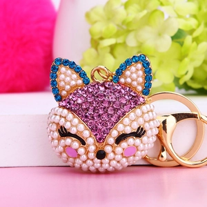 Sparkling fox head keychain with pink and blue rhinestones and white pearls on gold metal
