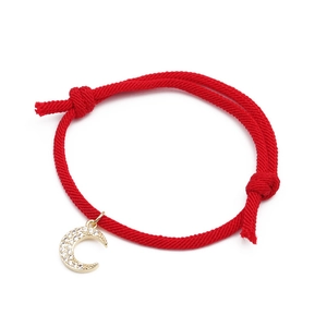 Red braided rope bracelet with gold crescent moon pendant featuring micro-pave crystals