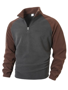 Detail of two-tone fleece sweatshirt with half-zip stand collar and textured polyester fabric