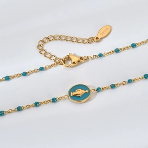 Collier en acier inoxydable doré avec perles turquoise et pendentif oiseau en émail bleu