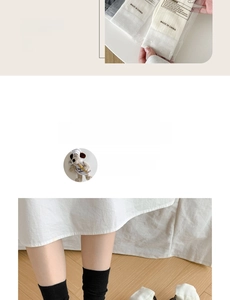 Detail of minimalist black and white crew socks in individual transparent packaging