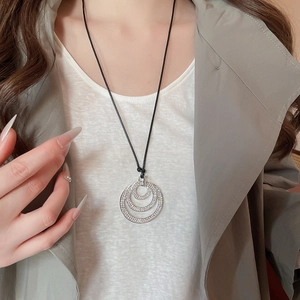 Close-up of geometric multi-layer circular pendant with sparkling crystal rhinestones