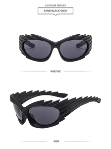 Detail view of matte black Y2K sunglasses with flame-shaped frames and grey lenses