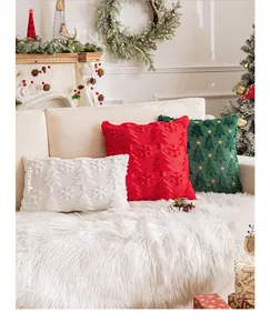 Close-up of tufted Christmas pillow covers with snowflake and tree embroidery on a sofa