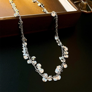Detailed close-up of a silver geometric sequin choker with shimmering metallic discs