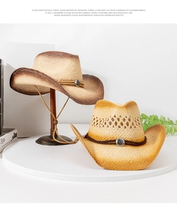 Detail of hand-woven straw cowboy hats featuring leather bands and sun totem buckles