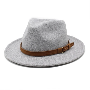 Detailed macro view of the grey wool felt fedora with brown leather buckle strap