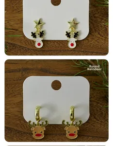 Detail of Christmas reindeer stud earrings with gold stars on a festive wooden background