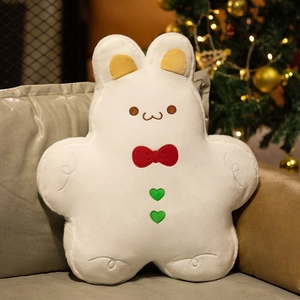 Detailed plush rabbit gingerbread pillow on sofa with festive Christmas tree background