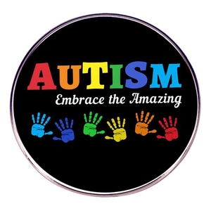 Round Autism Awareness metal badge with rainbow text and colorful handprints on black