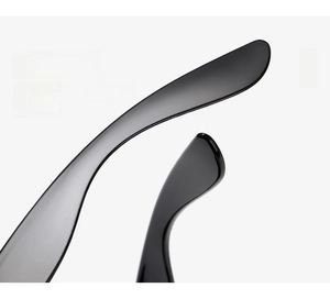 Detail of glossy black curved temple and hinge on vintage-style sunglasses